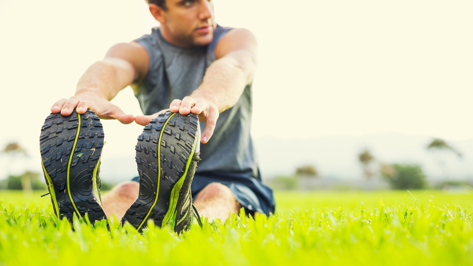 St. Louis athlete stretches on the grass