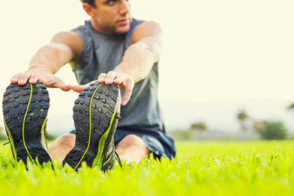St. Louis athlete stretches on the grass