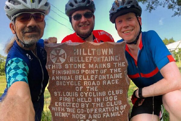 St. Louis cyclists with the Hilltown stone