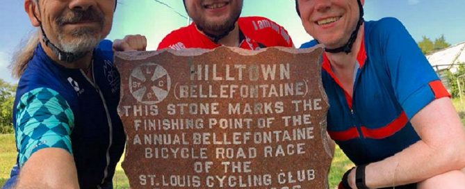 St. Louis cyclists with the Hilltown stone