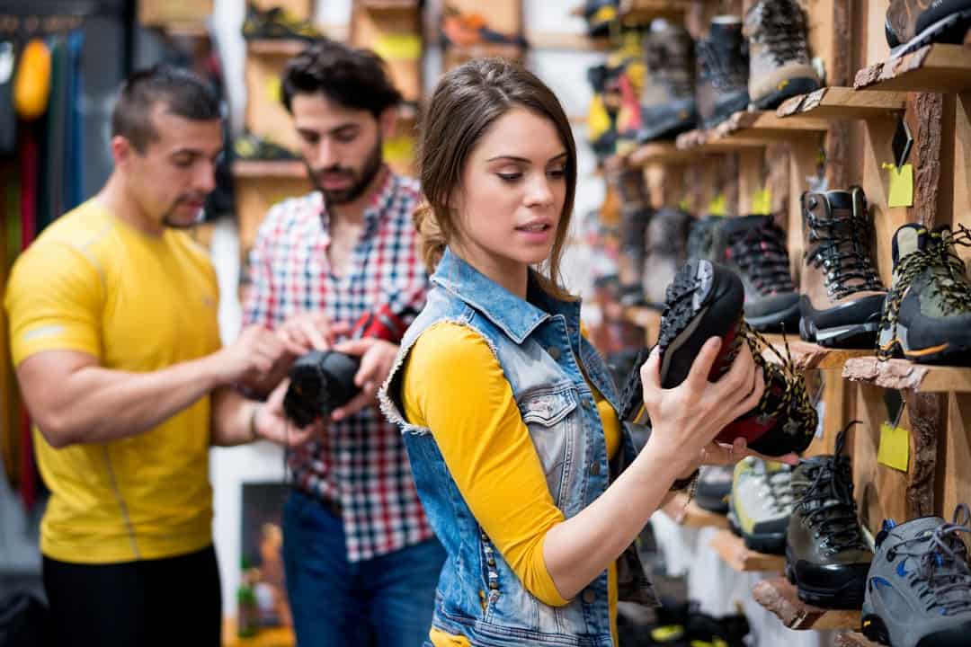 Woman in the store looking at hiking boot