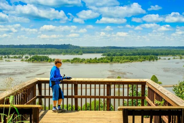 Man looking at Missouri River flooding