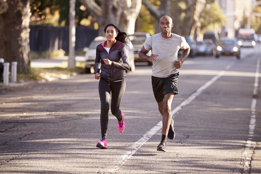 Young black couple jogging in a street