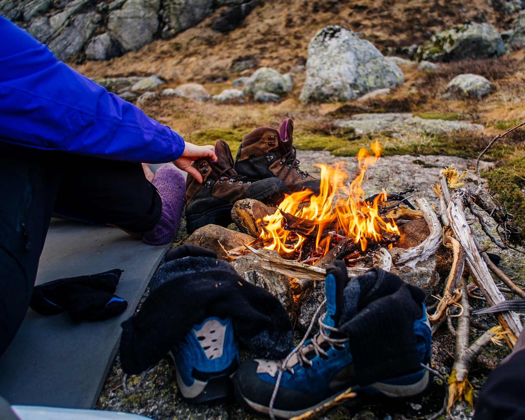 Hikers drying their boots by a campfire